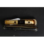 A cased bone and silver inlay cheroot / cigarette holder with original case