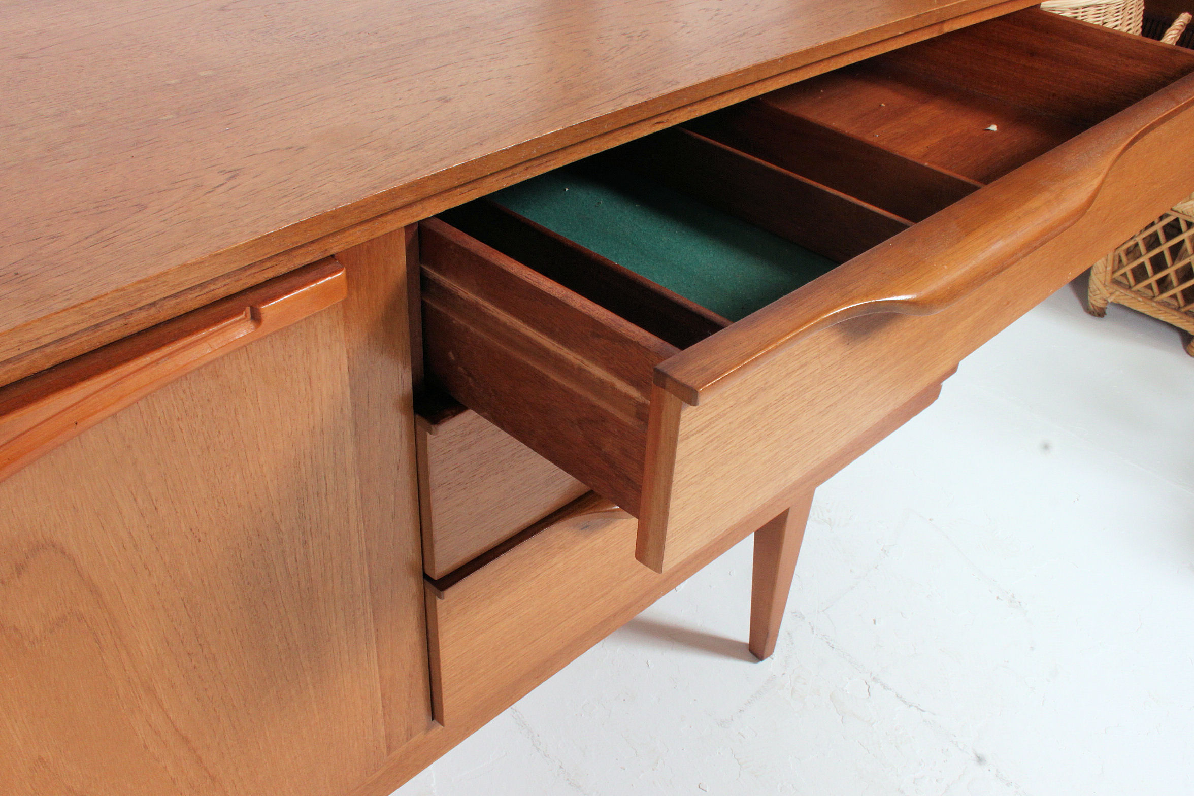 A retro 1970's Danish style teak wood low sideboard dresser raised on turned legs with a series of - Image 3 of 5