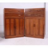 A near pair of utility oak tallboys, two drawers over two door cupboard c.