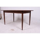 A 1970's  vintage retro mid century Scandart teak wood extending dining table raised on turned and