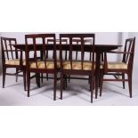 A 1970's retro afromosia teak large dining table and 6 chairs in the Danish style by Younger's.