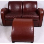 A 20th century brown / tan leather art deco style two seater leather sofa with curved sweeping arm