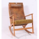 A Danish style teak wood rocking chair of angular form with padded seat and back rest in the manner