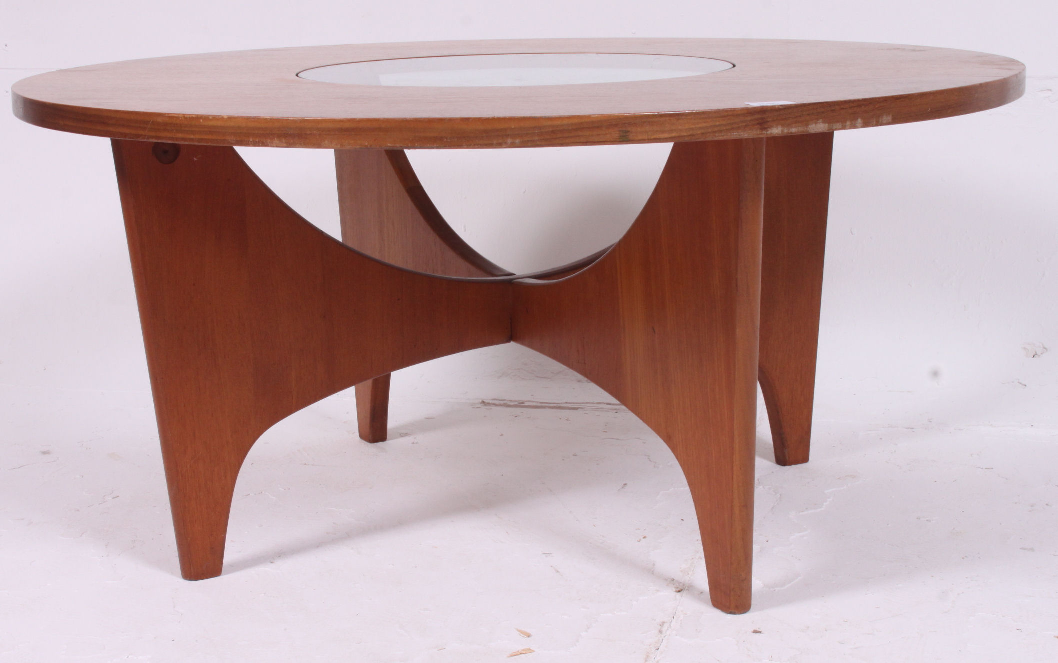 A Danish 1970's retro teak circular glass coffee table raised on sputnik style supports  having