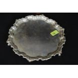 A large hallmarked silver Payton, Pepper & Sons salver standing on three claw feet,