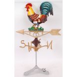 A contemporary heavy cast iron weather vane, with seated cockerel to top and moving pointer to base.