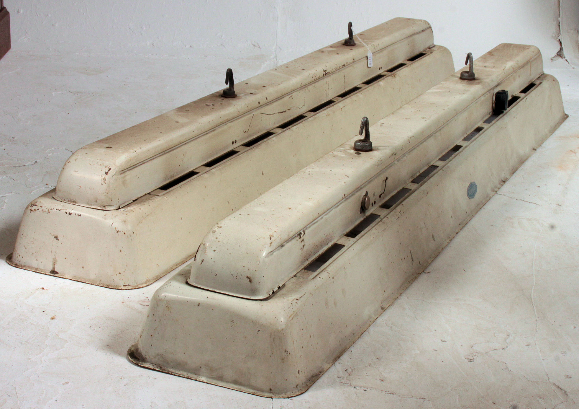 A pair of 1950's mid 20th century Industrial large Taskmaster enamel painted metal strip lights.