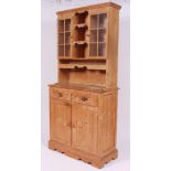 A 20th century antique style pine welsh dresser having a series of drawers and cupboards with