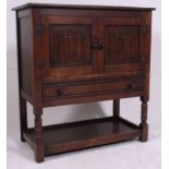 A Jaycee / Old Charm oak side cabinet in the Jacobean revival style.