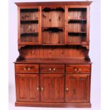 A 20th century contemporary pine dresser having a series of cupboards and drawers with upright top