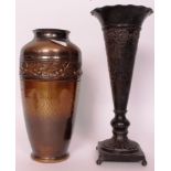 A vintage pressed metal vase having foli