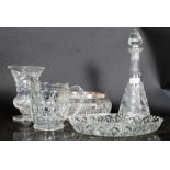 A large cut glass decanter along with other glassware.