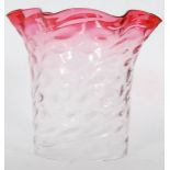 A good large cranberry and clear glass oil lamp shaped with scalloped cranberry glass top.