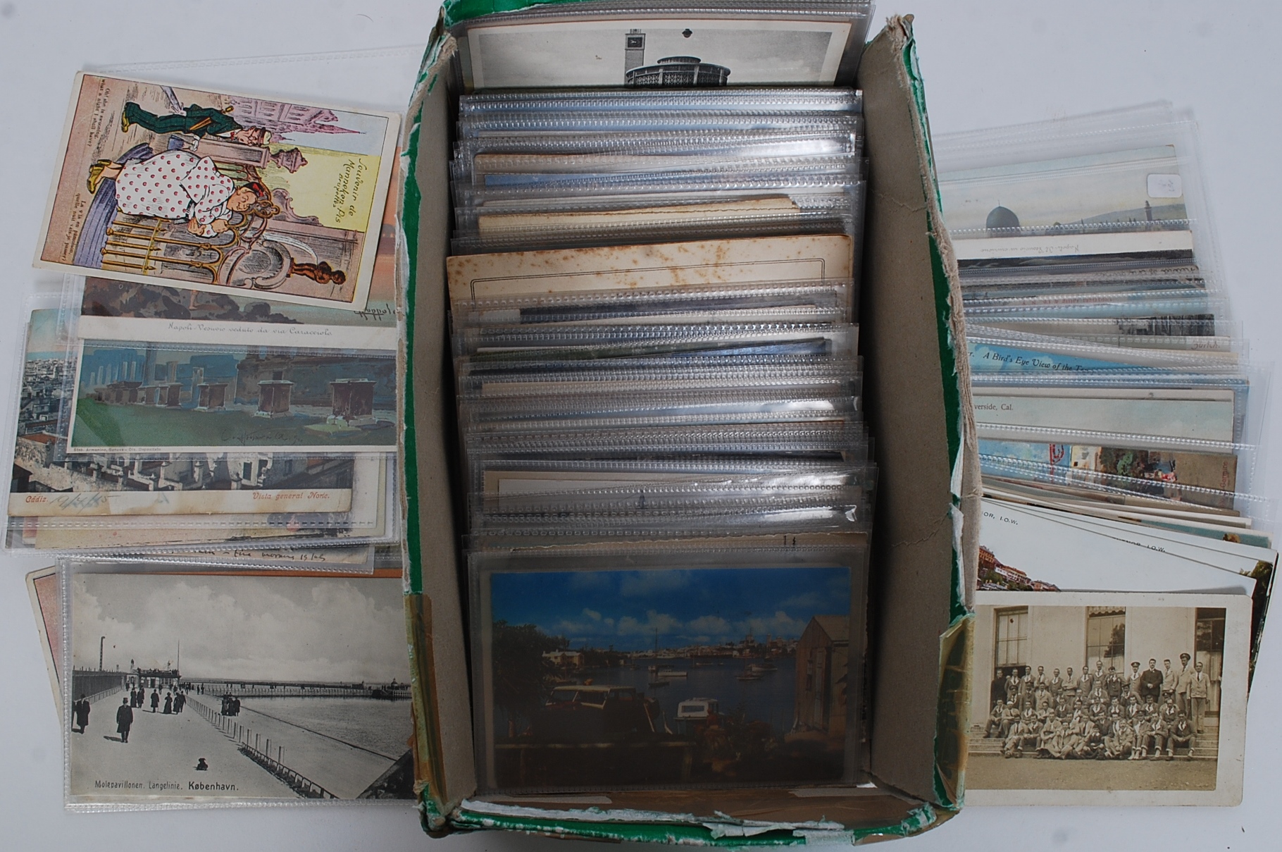 An assorted box of various vintage postcards,