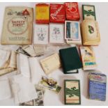 A small collection of vintage and retro playing cards along with some vintage cigarette cards,