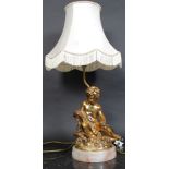 A gilt plaster work Cherub in classical pose table lamp mounted on marble base with shade H64cm