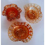 Two Fenton's marigold Carnival Glass baskets together with another example.