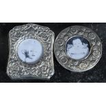 Two Victorian style silver plated photograph frames of rococo design, one being circular,
