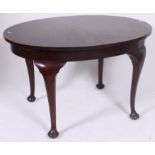 A 1930's mahogany oval extending dining table  all raised on cabriole legs.