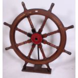 Late nineteenth century brass mounted oak and lignum vitae ships wheel with turned supports,