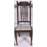 A set of 4 Edwardian Arts & Crafts oak dining chairs having tall railed back rests over drop in