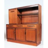 A 1970's G-Plan teak wood Fresco sideboard having a series of cupboards and drawers flanking an