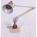 A 1940's Herbert Terry two step anglepoise Industrial desk lamp having square terraced base with