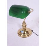 A 20th century contemporary brass base bankers / desk lamp having green shade on shaped column