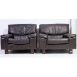 A pair of original Tetrad retro leather brown armchairs raised on squared supports with angular