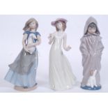 2 Nao by Lladro figurines to include Fashion Girl and Girl Standing holding rabbit in both hands.