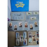 A large quantity of cigarette and tea cards - some loose,