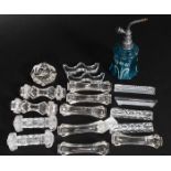 A collection of Victorian and later glass knife rests along with a blue glass perfume bottle