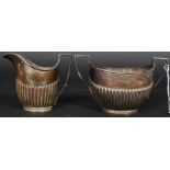 A matched set of hallmarked silver Queen Anne style ribbed sugar bowl and similar milk jug.