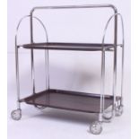 A retro 1970's metamorphic chrome metamorphic twin tier folding trolley with castors to the base.