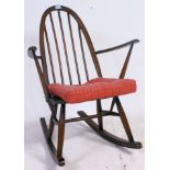 An Ercol golden dawn Windsor pattern stick back rocking chair, stamp to rear.