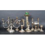 A collection of silver plated candelabras along with a silver plated table epergne.