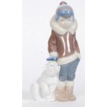 A Lladro figurine ' Eskimo Boy with Pet ' Bearing impressed model  No 5238 with blue stamp to base.