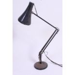 A post war black Herbert Terry Industrial office anglepoise desk lamp raised on circular base with