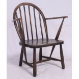A vintage Low Ercol style childs armchair having saddle seat with arched back and shaped elbow