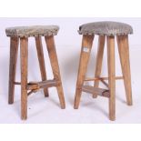 A near pair of vintage retro stools having studded seat pads, tapered legs.