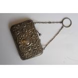 A silver hallmarked ladies purse and chain. Rococo scrollled design ( handle ( af) weight 39.