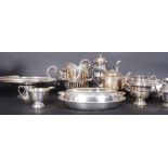 A large lot of antique silverplate items to include tea sets, candlesticks,