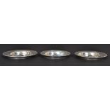 A set of 3 graduating silver hallmarked peanut dishes of circular form being engine turned.