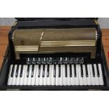 A vintage Hohner Accordion musical instrument, within the original case.