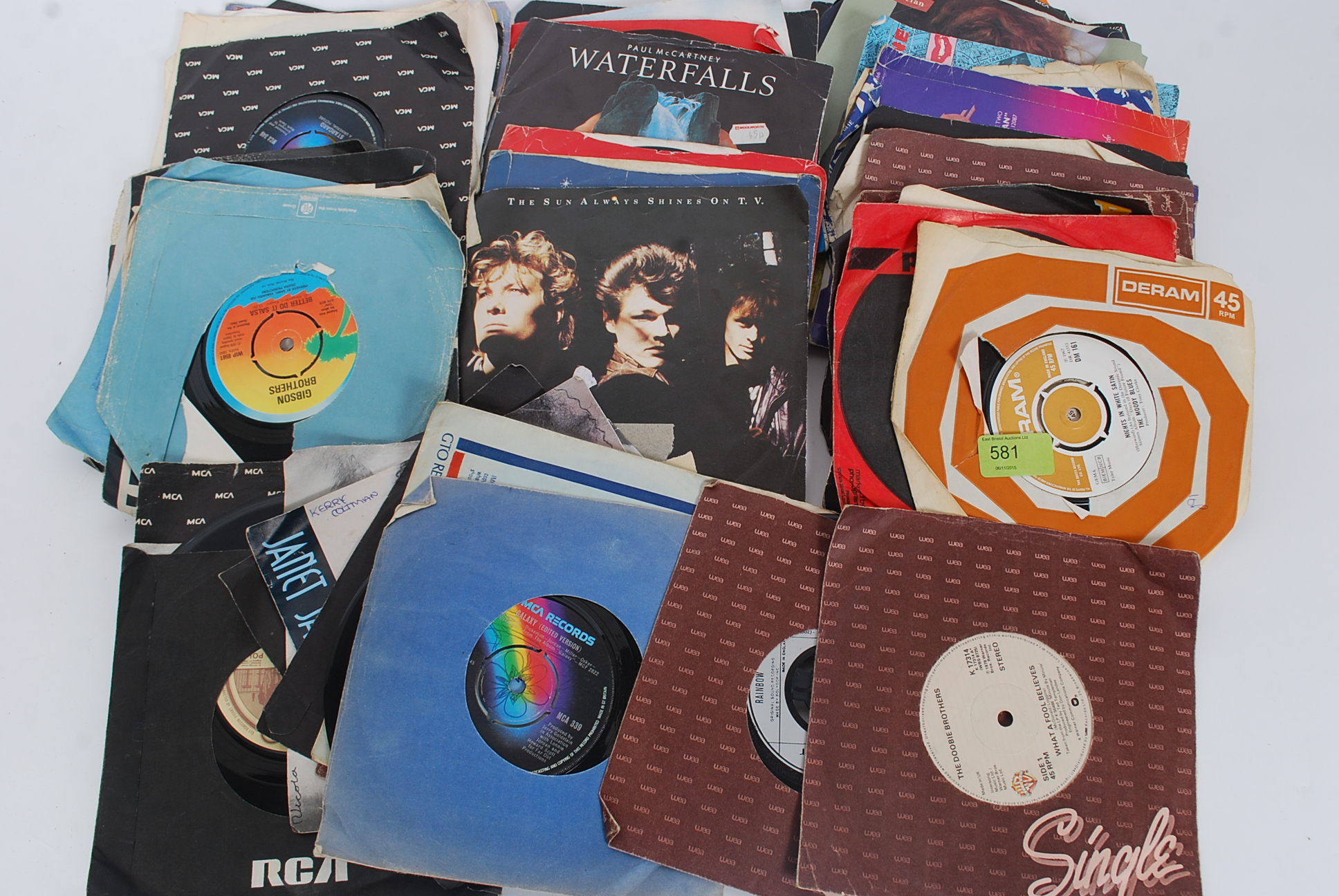 A collection of 45rpm 7" singles to include The Moody Blues, Rainbow, The Eagles, Supertramp,