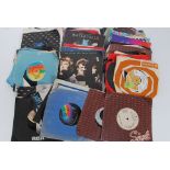 A collection of 45rpm 7" singles to include The Moody Blues, Rainbow, The Eagles, Supertramp,