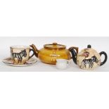 A Boston Tea party anniversary teapot by Davison Newman and co along with a teapot and cup and