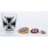 A collection of 20th century nazi memorabilia to include an enamel NSDAP badge being stamped to