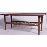 A 1960's coffee table, on turned legs with slatted tier beneath.