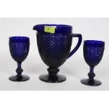 A Bristol Blue? pressed glass serving jug having a geometric pattern along with two matching